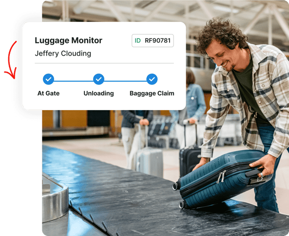 Smiling man picks up luggage at baggage claim; luggage monitor on screen shows bag status updates.