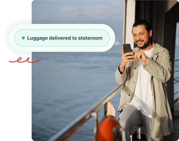 Man smiling while using smartphone on a ship deck with Luggage delivered to stateroom notification.