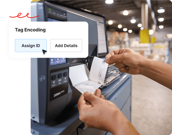 Hands holding a tag near a machine, with software options Assign ID and Add Details on screen.